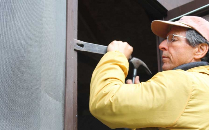 A person uses tools during a service project with Outward Bound.